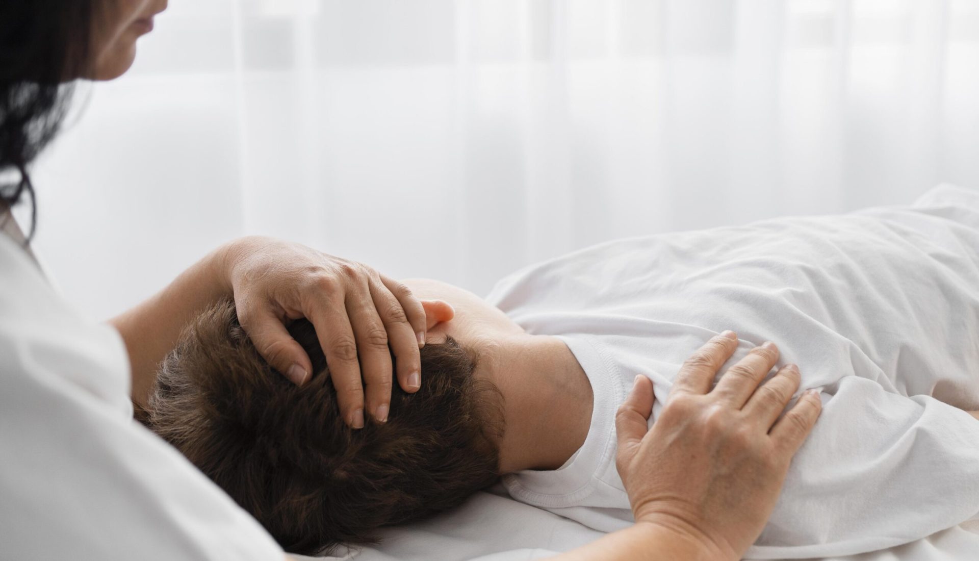 female-osteopathist-treating-boy-by-massaging-him (1)